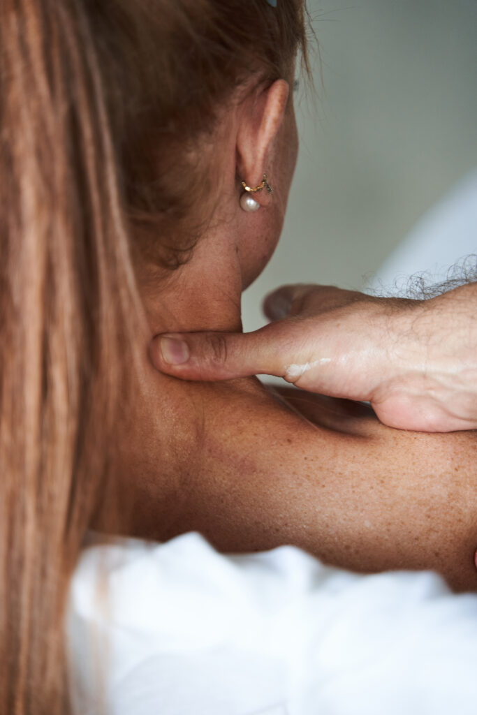 Pressure point on the neck during a massage therapy session